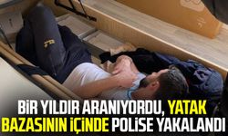 Bir yıldır aranıyordu, yatak bazasının içinde polise yakalandı